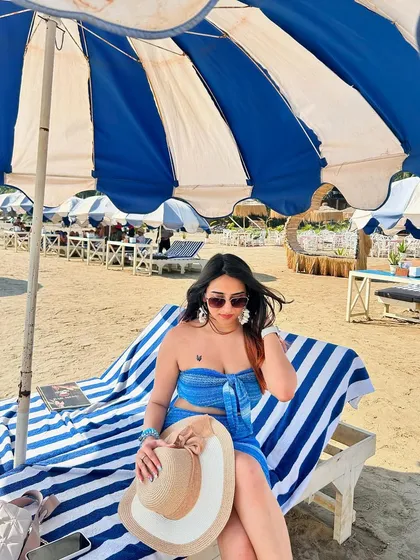 Lounging on a beach chair in Goa in a cute blue co-ord set. This is the classic, aspirational beach vacation shot that everyone loves.