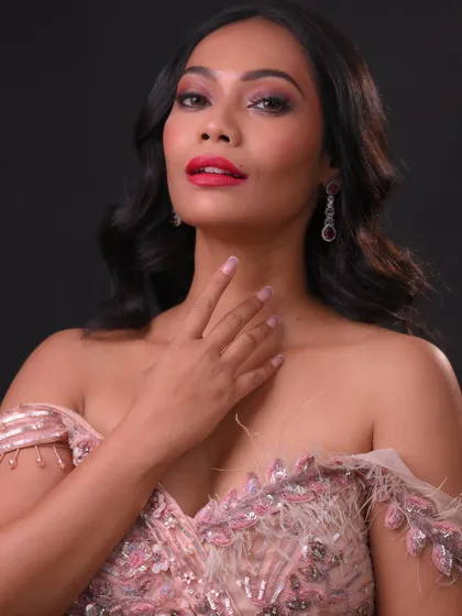 A close-up on the flawless makeup, with a focus on the perfectly applied red lipstick.