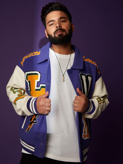 Cricketer Rishabh Pant in a statement Louis Vuitton varsity jacket. It’s a bold, youthful piece that instantly elevates a simple t-shirt and jeans.