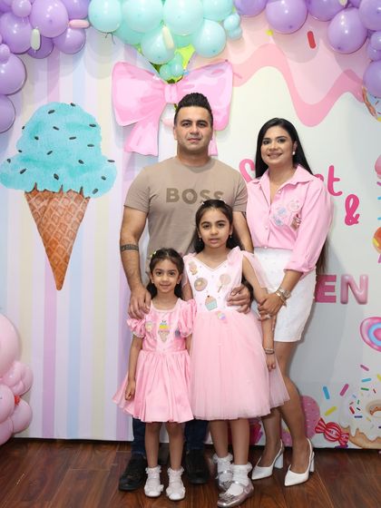 A beautiful family photo at the Candyland party. The coordinated pink outfits match the party's sweet aesthetic perfectly.