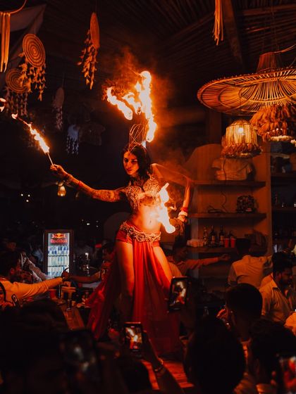 A wide shot of a solo performer on stage in front of a large, engaged audience. This demonstrates our experience with large crowds and creating a captivating atmosphere.