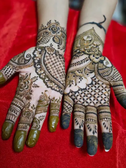 This Indo-Arabic design features a mix of styles, with a peacock and net pattern on one hand and a floral vine on the other.