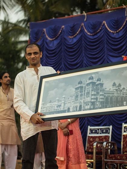 Gifting my Guruji, Sharath Jois, a framed photograph of the Mysore Palace is one of my most cherished memories. His simple encouragement to "keep taking photos and creating beautiful memories" has stayed with me. His guidance continues to be a light on my journey.