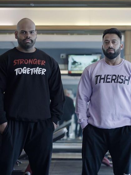 Stronger together. Standing with my brother in the gym. We push each other to achieve our goals.