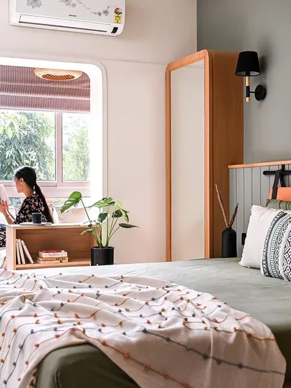 To make this master bedroom feel more spacious, I enclosed the balcony and raised the floor. This brought in abundant natural light and views of the greenery. An arched entryway defines the new cozy reading nook.