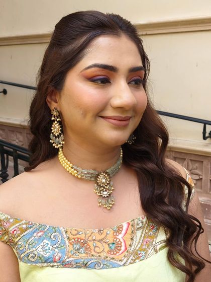 A closer look at the colorful eye makeup. The pop of orange and purple adds a fun twist to an otherwise natural look.