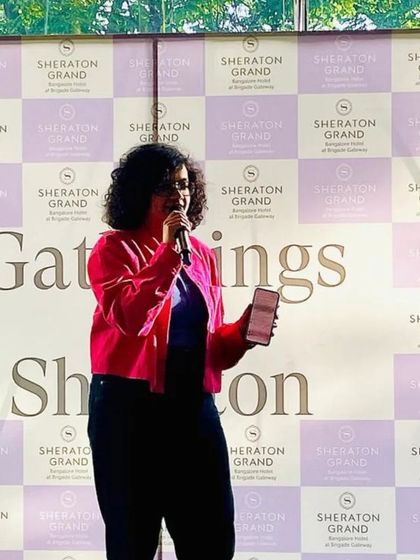 A poet performing at the "Gatherings by Sheraton" event, showing our ability to collaborate with major brands and host events in diverse, upscale venues.
