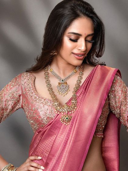 A candid-style bridal shot that captures a moment of joy. This approach brings a natural and relatable feel to bridal lookbooks, highlighting the beauty of the attire in a more personal way.