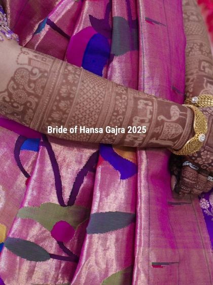 The arm of a storytelling mehendi, featuring bands of traditional motifs like elephants and peacocks. The light stain shows the clean line work before it fully darkens.