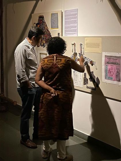 Artist Archana Hande explaining her work to a visitor.