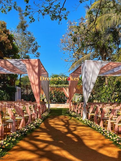 This shot captures the full length of the aisle, giving a sense of the scale and beauty of an outdoor wedding on our lawns.