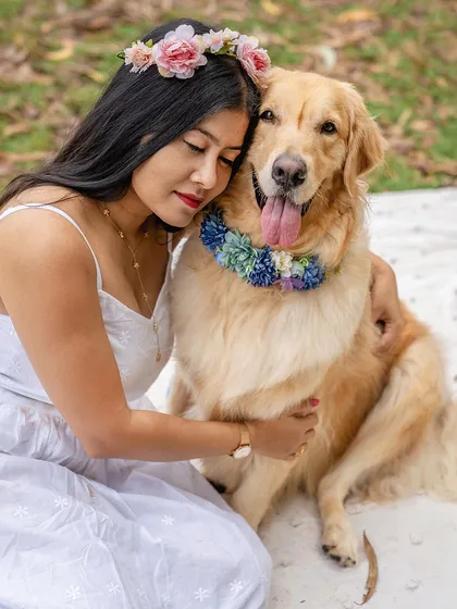A serene and loving portrait of a woman with a flower crown gently hugging her Golden Retriever. A perfect capture of the dog-mom bond.