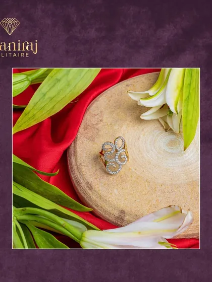 Elegance in every curve. This swirling diamond ring is a beautiful statement piece, pictured here among fresh lilies to highlight its natural, flowing design.