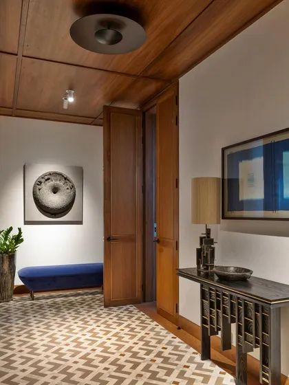 The entrance lobby sets the tone for the entire home, featuring a custom mosaic floor of marble, natural stone, and wood. This intricate flooring offers a glimpse into the rich material palette that we carried through the rest of the interiors.