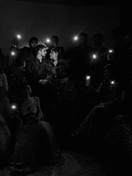 A creative and intimate group portrait with friends, using the light from their phones to illuminate the couple in the center. A modern take on a classic group shot.