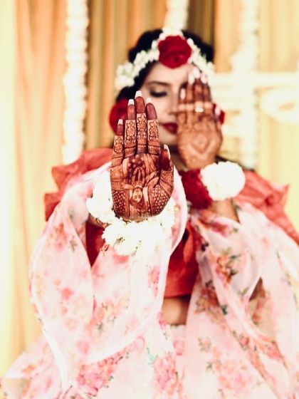 A creative shot of the bride showcasing the portrait on her palm.