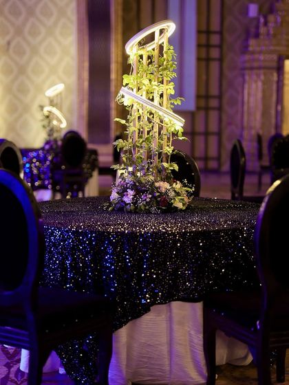 Cocktail tables at the techno Sangeet, featuring black sequin linens and the unique illuminated centerpieces, creating a cohesive and futuristic look.