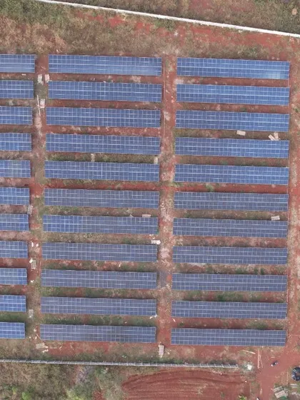 A top-down drone shot of the 1.3 MW solar farm, illustrating the precise layout and scale required for utility-grade power generation. Each row is optimized for maximum sun exposure and energy output.