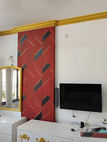 Don't be afraid to go bold. This installation features a striking red and black geometric wallpaper that acts as a powerful focal point in the bedroom. It’s a great example of how a dynamic pattern can energize a room and reflect a client's personality.
