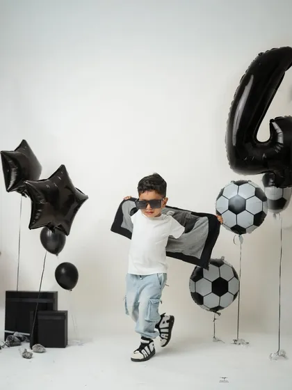 A dynamic action shot of the birthday boy, running with a cape-like jacket. I love capturing the energy and personality of older kids during their milestone sessions.