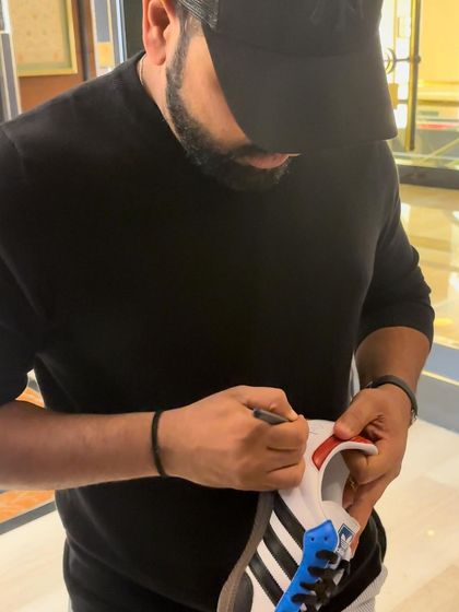 Indian cricket captain Rohit Sharma signing a custom pair of Adidas Sambas I designed for him.
