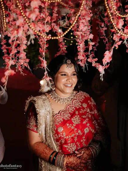 A close-up of the bride's happy smile, surrounded by beautiful decor.