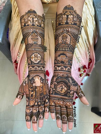 A royal bridal mehendi with majestic elephants at the top, leading down to the Varmala ceremony and the couple's initial on the other palm.