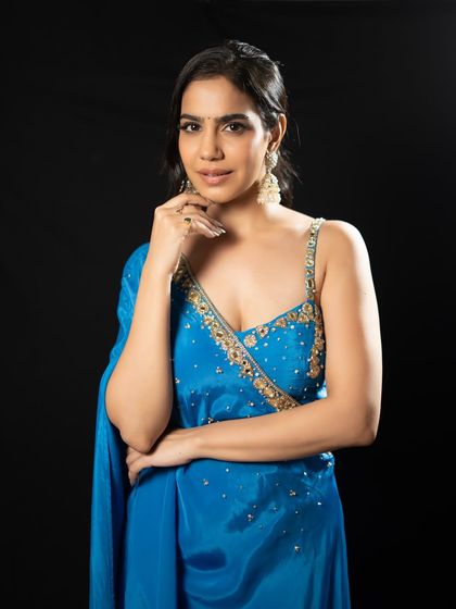 Glam quotient always high. This blue saree-style gown is perfect for a sophisticated reception or cocktail evening.