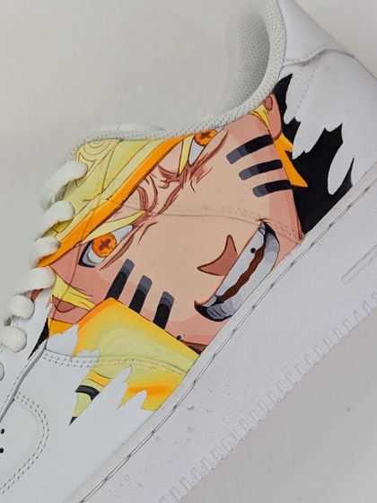 A detailed shot of the Naruto Sage Mode side. The vibrant orange and yellow really stand out against the white sneaker, showing off the power of the Seventh Hokage.