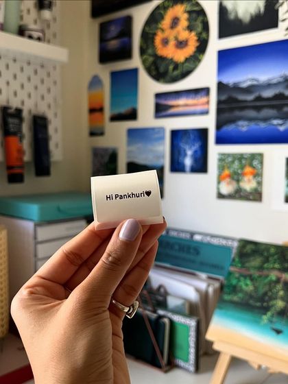 Holding the sweet note against the backdrop of my art wall.