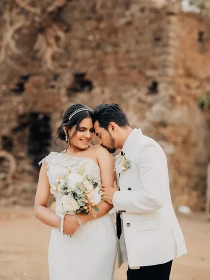 A tender moment captured against the rustic stone wall. Even in a formal, editorial shoot, I look for these instances of genuine affection.