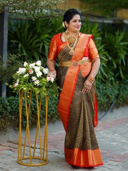 Our client Shilpa looks regal in this statement silk saree with brown and red stripes, a bold and beautiful choice.