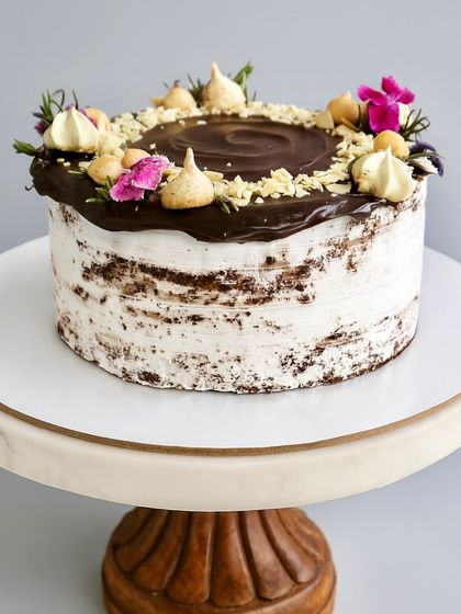 For those who love a bold and nutty cake, I created the Chocolate Hazelnut Naked Cake. It has a decadent chocolate sponge, dark chocolate ganache, a layer of Nutella, and is topped with roasted hazelnuts and almonds for a wonderful crunch.