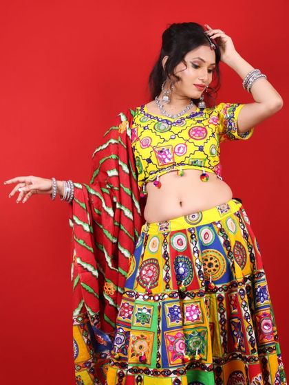 A playful pose in a traditional Garba outfit. The makeup features a pop of yellow on the eyes to match the colorful attire.