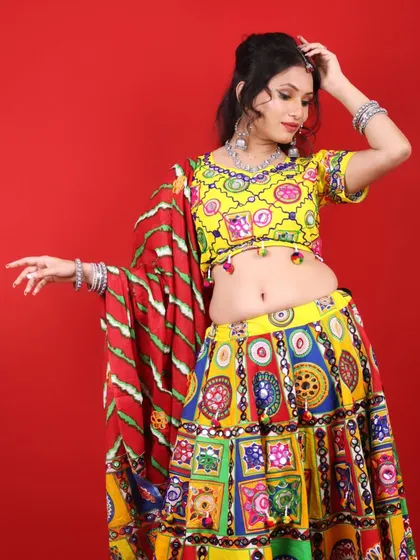 A playful pose in a traditional Garba outfit. The makeup features a pop of yellow on the eyes to match the colorful attire.