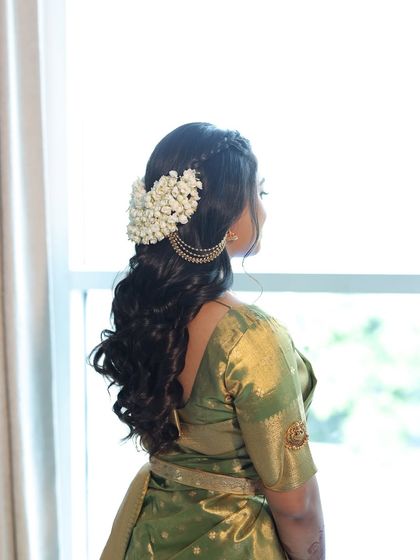 A side view of the beautiful South Indian hairstyle. The fresh mogra flowers add a beautiful fragrance and a touch of tradition to the look.