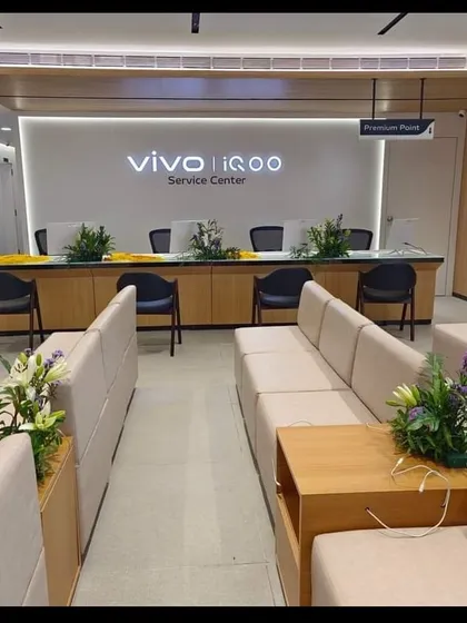 The clean and organized service center area for VIVO and iQOO, designed for customer comfort and efficient workflow. The space features comfortable seating and a clear, welcoming reception desk.