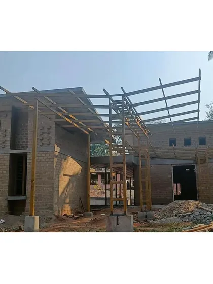 The entrance structure under construction. This frame provides a glimpse into the building's core, where the community courtyard will eventually be, establishing a welcoming entry point.