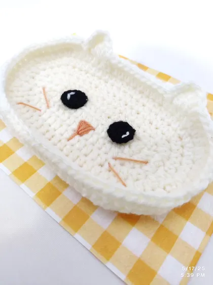The cat-faced trinket dish shown on its own, highlighting the cute embroidered face details.