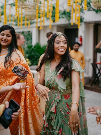 A candid shot of the bride dancing at her Mehendi. The makeup is light and fresh, allowing her to enjoy the festivities without feeling weighed down.