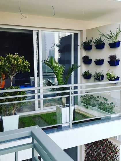 A small but well-designed balcony. We used vertical wall planters to maximize greenery without sacrificing floor space.