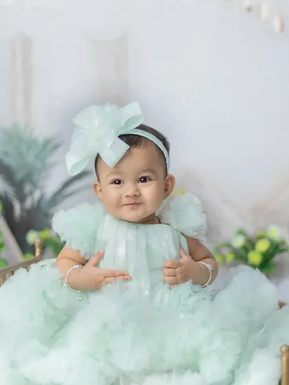 A happy smile from her little golden bed. This pose makes her look like royalty in her beautiful dress.