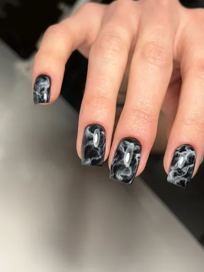 Another example of the black and white marble smoke effect on a different nail shape, showing how the technique can be adapted.