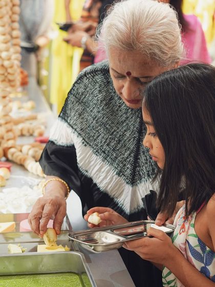 A grandmother and her granddaughter enjoying the interactive 'bread and butter' food installation. We love creating culinary experiences that are fun and engaging for all ages.