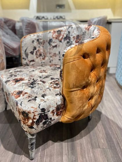 A showcase of my versatile accent chair designs. This includes a green velvet chair with a tufted back, and another model combining floral-print fabric with a mustard-yellow tufted back.