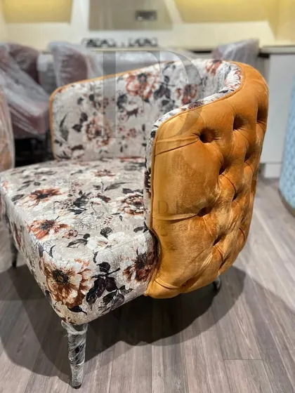 A showcase of my versatile accent chair designs. This includes a green velvet chair with a tufted back, and another model combining floral-print fabric with a mustard-yellow tufted back.