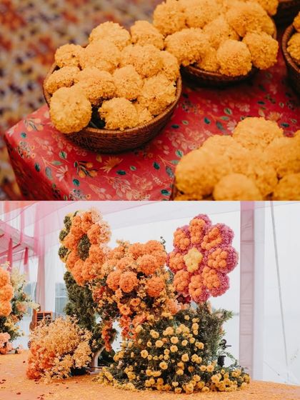 A detailed look at floral elements from a haldi ceremony. It shows traditional motichoor laddus alongside large, creative flower installations made from marigolds.
