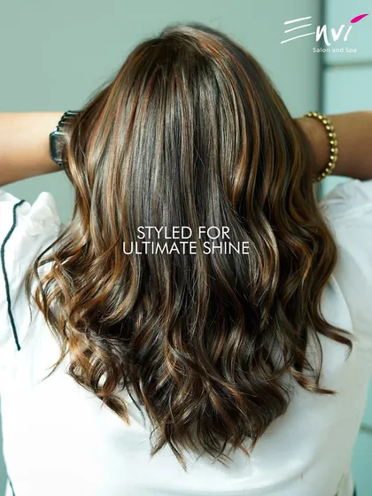 Styled for ultimate shine. This photo showcases how our coloring techniques, combined with expert styling, result in hair that gleams with health and vibrancy.