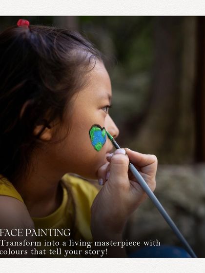 A young girl gets her face painted at the World Food Carnival. We offer engaging activities like face painting to make the experience magical for our younger guests.