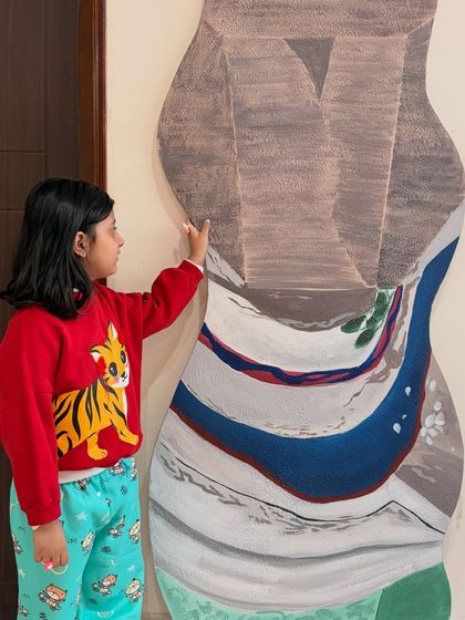 My little helper admiring a 6ft tall custom piece for a Mumbai home. This artwork, painted on a custom-shaped board, incorporates landscapes and natural elements that are meaningful to the client.